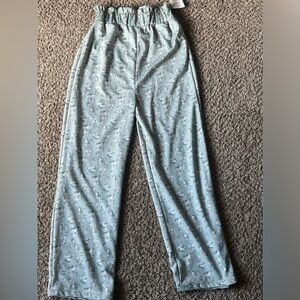 Light green pants with little flowers on them the material is POLYESTER